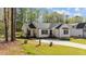 Charming white home with a well-manicured lawn and inviting front porch at 132 Prairie Dog Dr, Louisburg, NC 27549