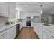 Bright open kitchen with white cabinetry, quartz countertops and island at 132 Prairie Dog Dr, Louisburg, NC 27549