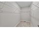 Empty walk-in closet with shelving, carpet, and neutral paint at 132 Prairie Dog Dr, Louisburg, NC 27549