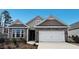 Charming home with stone accents, neutral siding, a two-car garage, and professionally landscaped yard at 1688 Abberly Pl, Graham, NC 27253