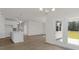 Bright living space featuring hardwood floors, a modern chandelier, and access to the porch at 1688 Abberly Pl, Graham, NC 27253