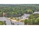 A recreational spot sits next to the lake surrounded by a lush forest and a sandy beach at 200 Rawhide Dr, Louisburg, NC 27549