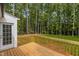 Enjoy outdoor living on the wooden deck, overlooking the private backyard surrounded by trees at 200 Rawhide Dr, Louisburg, NC 27549