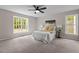 Spacious bedroom with two windows that allows plenty of natural light and a ceiling fan at 200 Rawhide Dr, Louisburg, NC 27549