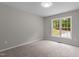 Neutral bedroom with plenty of natural light, carpet flooring, and an electrical outlet at 200 Rawhide Dr, Louisburg, NC 27549