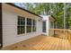 A wooden deck on a house featuring a white exterior and beautiful views of the surrounding landscape at 200 Rawhide Dr, Louisburg, NC 27549