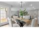 Open-concept dining room with views of the kitchen and living room, filled with natural light at 200 Rawhide Dr, Louisburg, NC 27549