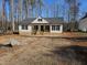 Newly constructed home boasts a charming exterior with white siding and black shutters at 200 Rawhide Dr, Louisburg, NC 27549