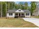 Charming single-story home with a welcoming front porch, black shutters, and manicured lawn at 200 Rawhide Dr, Louisburg, NC 27549