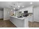 Bright, modern kitchen with white cabinets, stainless steel appliances, and a center island at 200 Rawhide Dr, Louisburg, NC 27549