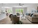 Spacious living room featuring contemporary furnishings, wood-look floors, and backyard views at 200 Rawhide Dr, Louisburg, NC 27549