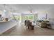 Bright open-concept living space with modern décor, wood floors, and a view of the backyard at 200 Rawhide Dr, Louisburg, NC 27549