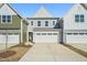 Charming townhome with a two-car garage and inviting curb appeal on a bright, sunny day at 909 Montague Ave, Durham, NC 27703