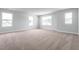 Spacious bedroom featuring neutral carpeting, ample natural light, and multiple windows at 105 Wilderness Ct, Mebane, NC 27302