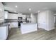 Bright kitchen with white cabinets, granite countertops, stainless appliances, and a convenient island at 105 Wilderness Ct, Mebane, NC 27302
