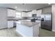 Well-lit kitchen featuring stainless steel appliances, granite countertops, and a center island at 105 Wilderness Ct, Mebane, NC 27302