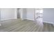 Open-concept space with light vinyl floors, white trim, and easy access to the kitchen at 105 Wilderness Ct, Mebane, NC 27302