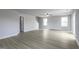 Spacious living room featuring lots of natural light, grey walls, and wood-look flooring at 105 Wilderness Ct, Mebane, NC 27302