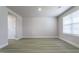 Bright living room with neutral walls, light vinyl floors, and a large window allowing natural light at 105 Wilderness Ct, Mebane, NC 27302