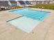 Aerial view of a community pool with a zero entry, lap lanes, and neighborhood homes at 105 Wilderness Ct, Mebane, NC 27302