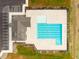 Aerial view of a community pool, parking, and clubhouse with well-manicured landscaping at 105 Wilderness Ct, Mebane, NC 27302