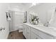Dual sink bathroom featuring white cabinets, quartz countertops, and modern fixtures at 10535 Pleasant Branch Dr # 201, Raleigh, NC 27614