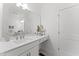 Bright bathroom showcasing a large mirror, white cabinetry, and elegant fixtures at 10535 Pleasant Branch Dr # 201, Raleigh, NC 27614