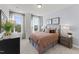 Comfortable bedroom with a cozy bed, two windows with lush outdoor views, and coordinated decor at 10535 Pleasant Branch Dr # 201, Raleigh, NC 27614
