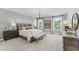 Large primary bedroom with elegant decor, including a modern chandelier and stylish furnishings at 10535 Pleasant Branch Dr # 201, Raleigh, NC 27614