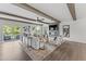 Bright living room boasts neutral tones, beamed ceilings, fireplace, and a large balcony overlooking greenery at 10535 Pleasant Branch Dr # 201, Raleigh, NC 27614