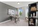 Well-lit home office with a rustic desk, decorative shelving, and a cozy reading nook at 10535 Pleasant Branch Dr # 201, Raleigh, NC 27614