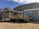 Outdoor deck with stairs leads to a spacious, landscaped yard, ideal for relaxation and entertainment at 1600 Maelyn Way, Fuquay Varina, NC 27526