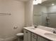 Bathroom features a double sink vanity with stone countertops and tiled flooring, creating a modern aesthetic at 1600 Maelyn Way, Fuquay Varina, NC 27526