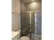 Bathroom features a walk-in shower with a built-in seat, modern fixtures, and tile surround at 1600 Maelyn Way, Fuquay Varina, NC 27526