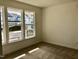 Bright bedroom featuring neutral walls and carpet with three windows for natural light at 1600 Maelyn Way, Fuquay Varina, NC 27526