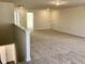 Large open loft area with neutral walls and carpet, perfect for a play area or second living space at 1600 Maelyn Way, Fuquay Varina, NC 27526