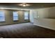 Large open loft area with neutral walls and carpet, featuring great natural light at 1600 Maelyn Way, Fuquay Varina, NC 27526