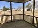 Enclosed porch with wood flooring and framed views of a spacious yard with mature trees and surrounding structures at 1600 Maelyn Way, Fuquay Varina, NC 27526