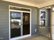 From the porch, a sliding glass door reveals a glimpse into the interior, showcasing the modern kitchen at 1600 Maelyn Way, Fuquay Varina, NC 27526