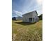 View of the home's rear exterior showing the siding, windows and backyard space at 178 Vili Dr, Broadway, NC 27505
