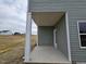Covered back porch or patio with concrete flooring, providing a relaxing outdoor space at 178 Vili Dr, Broadway, NC 27505