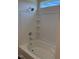 Bathroom tub and shower combo with white tile and a small window at 178 Vili Dr, Broadway, NC 27505
