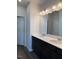 Bathroom vanity features dual sinks, black cabinets, and a large mirror at 178 Vili Dr, Broadway, NC 27505