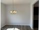 Dining room featuring a modern chandelier and wood-look flooring at 178 Vili Dr, Broadway, NC 27505