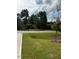 Manicured front lawn of a home with grass and new tree at 178 Vili Dr, Broadway, NC 27505