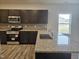 Well-equipped kitchen features granite countertops, stainless steel appliances, and dark wood cabinets at 178 Vili Dr, Broadway, NC 27505