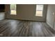 Bright living room with wood-look flooring and natural light from large windows at 178 Vili Dr, Broadway, NC 27505