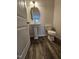 Powder room with pedestal sink, elongated toilet, and hardwood floors at 178 Vili Dr, Broadway, NC 27505