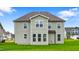 Backyard with green vinyl siding, energy efficient windows, and a well-manicured lawn at 2750 Lacy Holt Rd, Graham, NC 27253