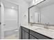 Bathroom with double vanity, large mirror, and a view to the tub at 2750 Lacy Holt Rd, Graham, NC 27253